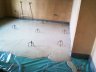 Shows screed placed in room with radiators as source of heating - 